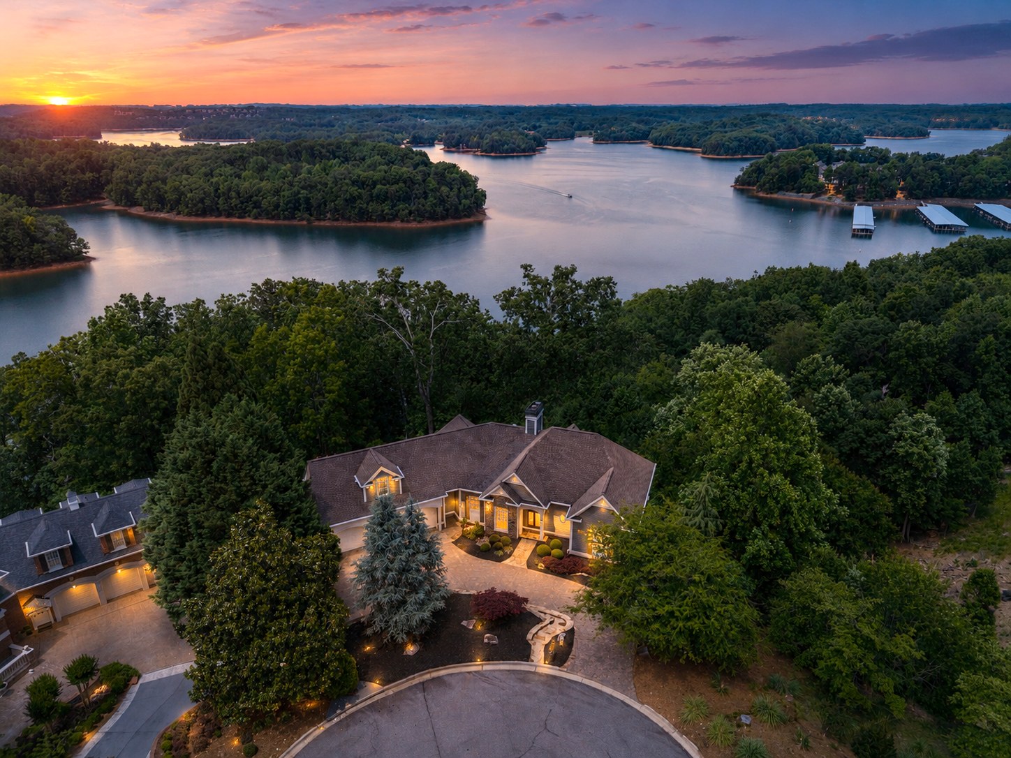 Aerial view of a Harbour Point lakefront home at sunset on Lake Lanier